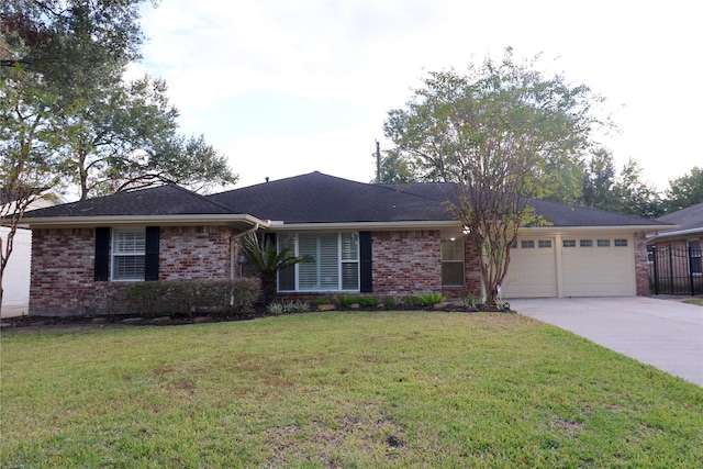 single story home featuring a garage and a front lawn