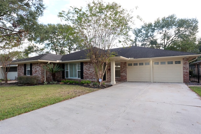 single story home with a front yard and a garage