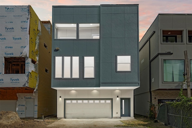 outdoor building at dusk featuring a garage