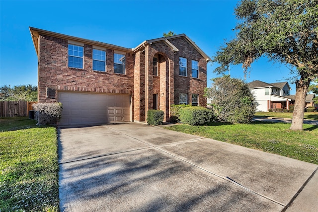 view of front of house featuring a garage and a front lawn