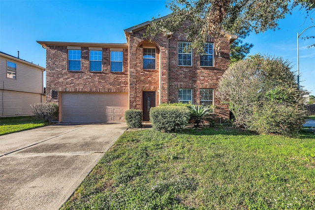 view of front of property with a front yard and a garage