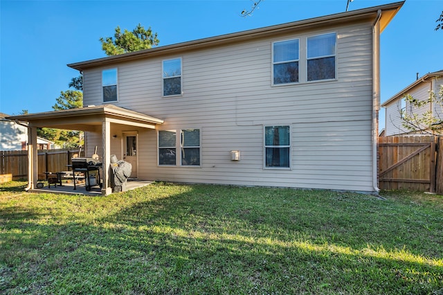 rear view of property with a patio area and a yard