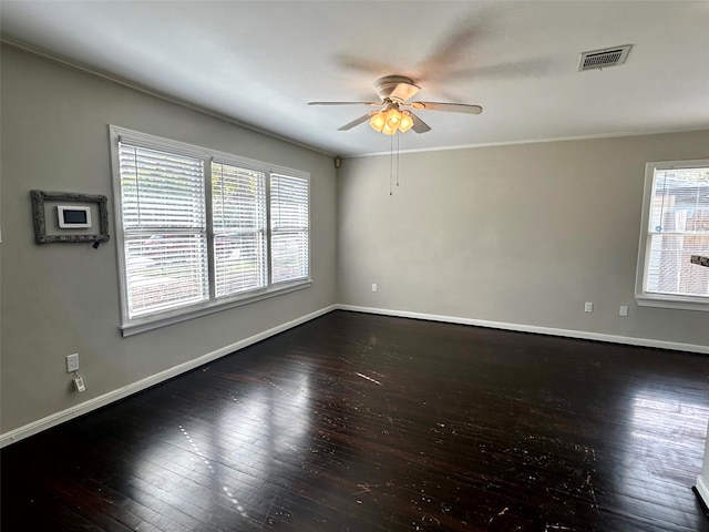 unfurnished room with dark hardwood / wood-style floors, plenty of natural light, ornamental molding, and ceiling fan