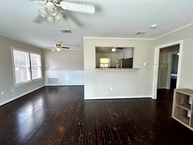 unfurnished living room featuring dark hardwood / wood-style floors and ornamental molding