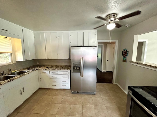 kitchen featuring white cabinets, decorative backsplash, stainless steel appliances, and sink