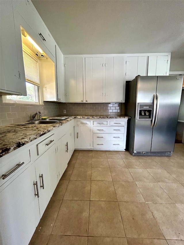 kitchen featuring white cabinets, stainless steel fridge with ice dispenser, and sink