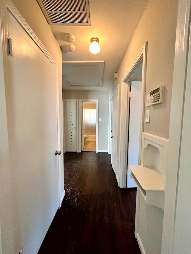 corridor featuring dark hardwood / wood-style flooring