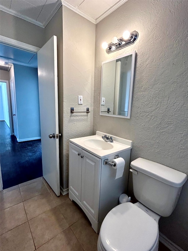 bathroom featuring tile patterned floors, vanity, toilet, and ornamental molding