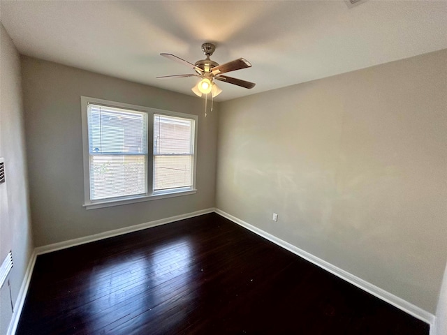 unfurnished room with ceiling fan and dark wood-type flooring