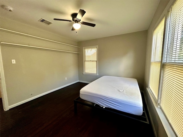 bedroom featuring ceiling fan and dark hardwood / wood-style flooring