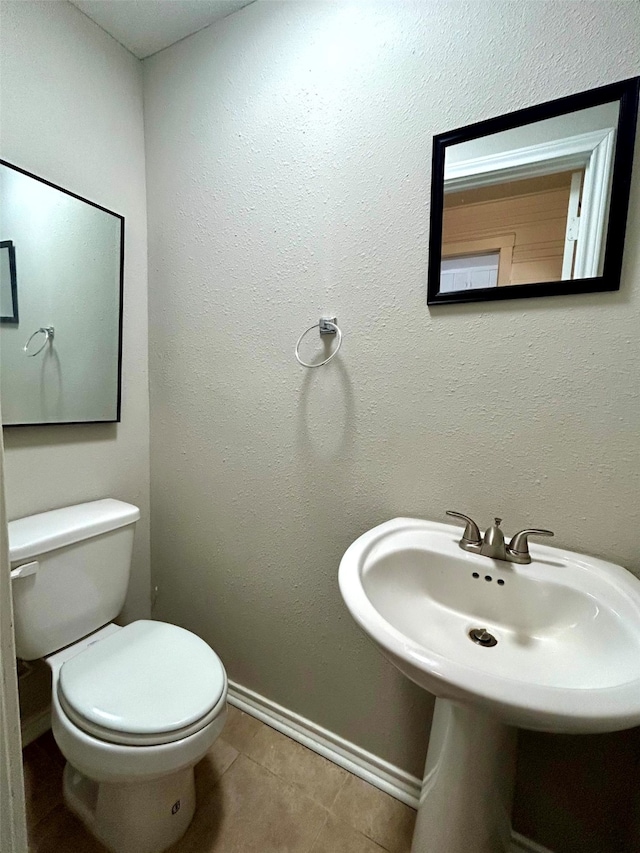 bathroom featuring tile patterned floors and toilet