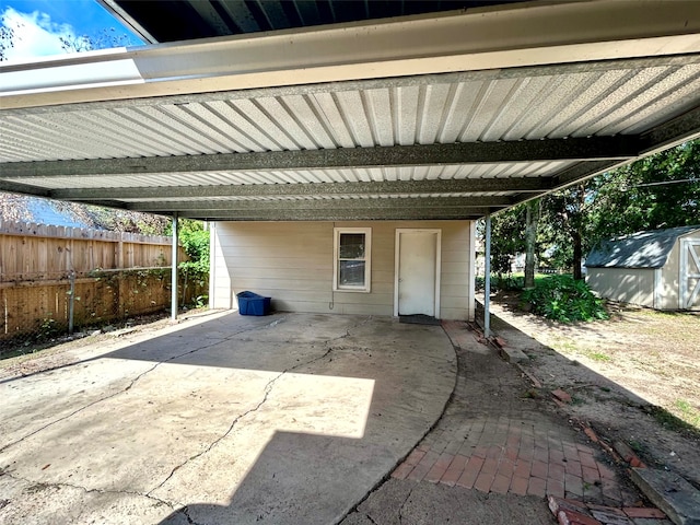 view of patio with a carport and a storage shed