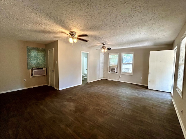 unfurnished room featuring ceiling fan, cooling unit, dark wood-type flooring, and a textured ceiling