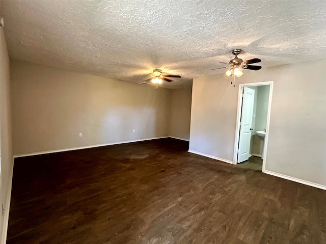 unfurnished room featuring a textured ceiling and dark wood-type flooring