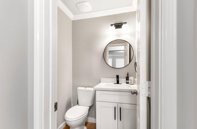 bathroom with vanity, toilet, and crown molding