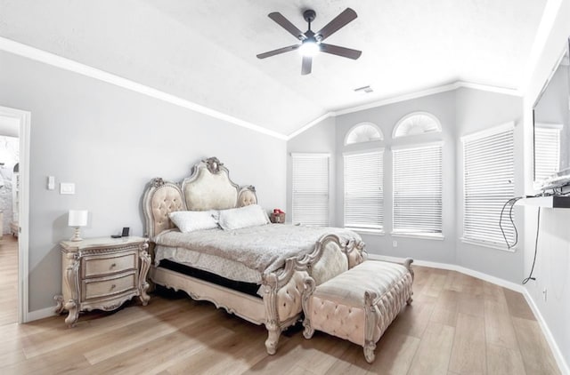 bedroom featuring ceiling fan, ornamental molding, lofted ceiling, and light wood-type flooring