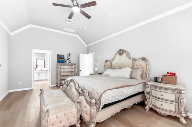 bedroom featuring ceiling fan, crown molding, wood-type flooring, connected bathroom, and lofted ceiling