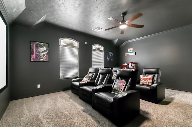 cinema room featuring carpet, lofted ceiling, crown molding, ceiling fan, and a textured ceiling