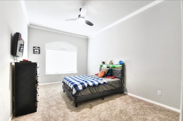 carpeted bedroom featuring ceiling fan and ornamental molding