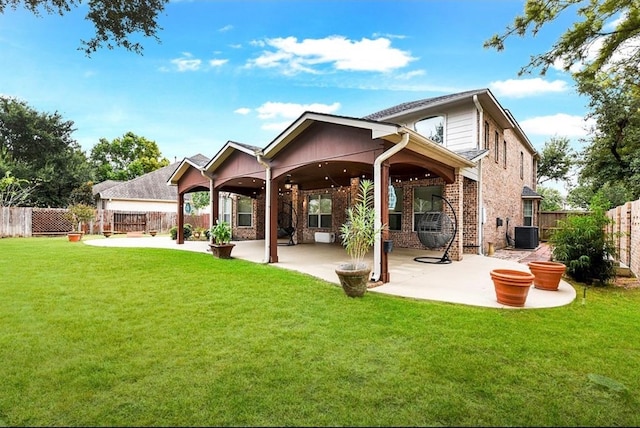 back of property with a patio, central AC unit, and a lawn