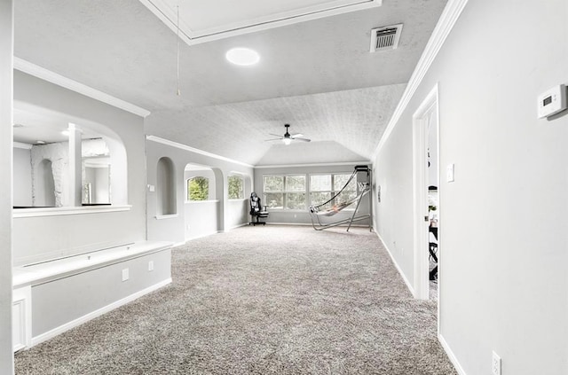 unfurnished living room featuring carpet flooring, ceiling fan, lofted ceiling, and crown molding