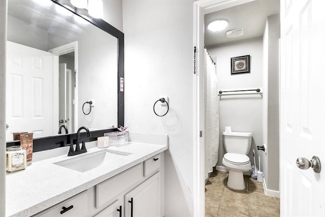 bathroom featuring toilet, vanity, and tile patterned floors