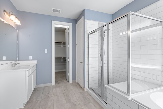 bathroom featuring vanity and shower with separate bathtub