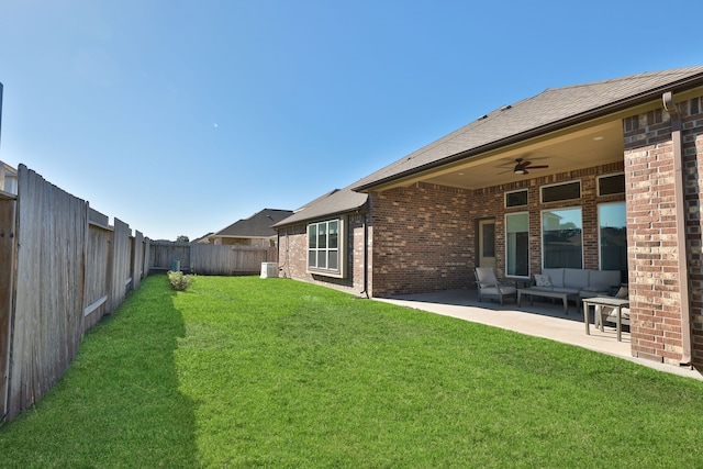 view of yard with outdoor lounge area, ceiling fan, a patio area, and central AC