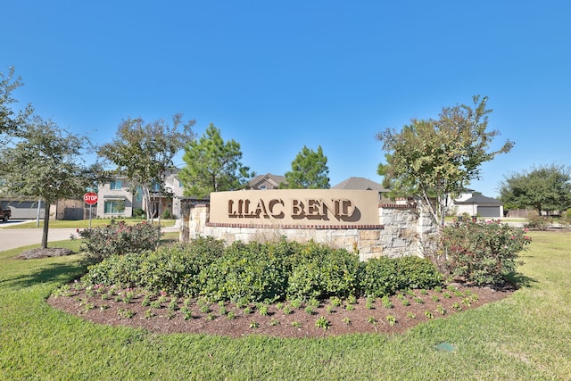 community / neighborhood sign with a lawn