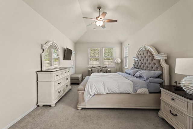 bedroom with ceiling fan, light carpet, and vaulted ceiling