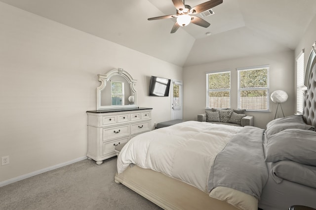 carpeted bedroom with ceiling fan, vaulted ceiling, and multiple windows