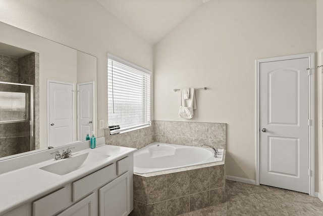 bathroom with tile patterned floors, vanity, lofted ceiling, and shower with separate bathtub