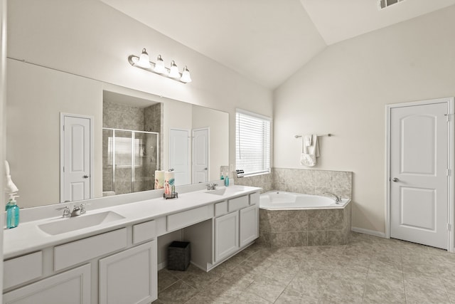 bathroom with tile patterned flooring, vanity, plus walk in shower, and vaulted ceiling