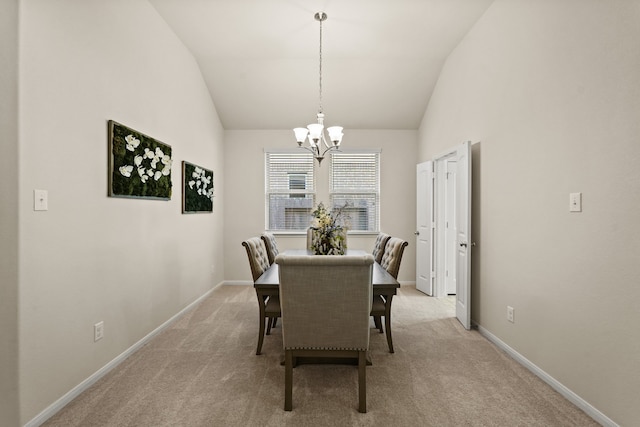 dining room featuring lofted ceiling, light carpet, and a chandelier