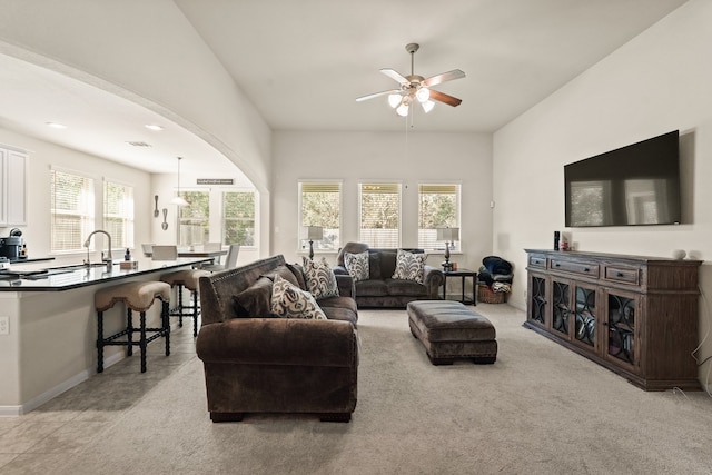 living room with light carpet and ceiling fan