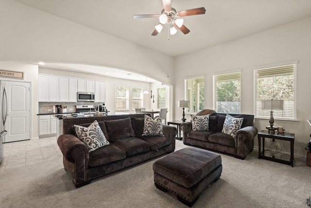 carpeted living room featuring ceiling fan and a healthy amount of sunlight