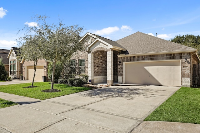 view of front of property with a front yard and a garage