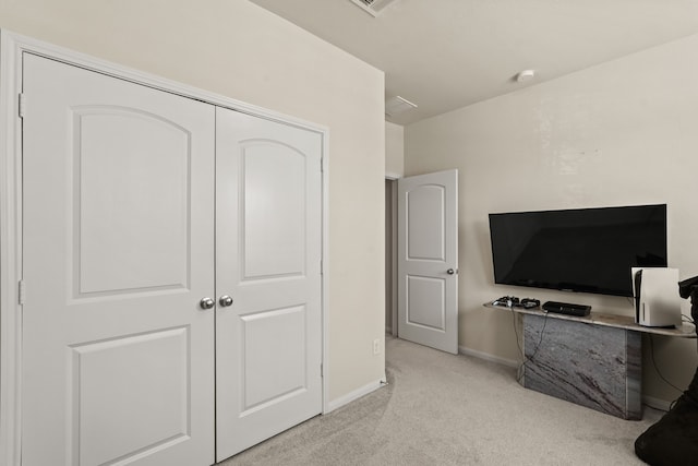 bedroom featuring a closet and light colored carpet