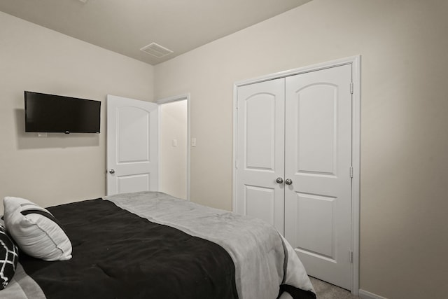 carpeted bedroom with a closet