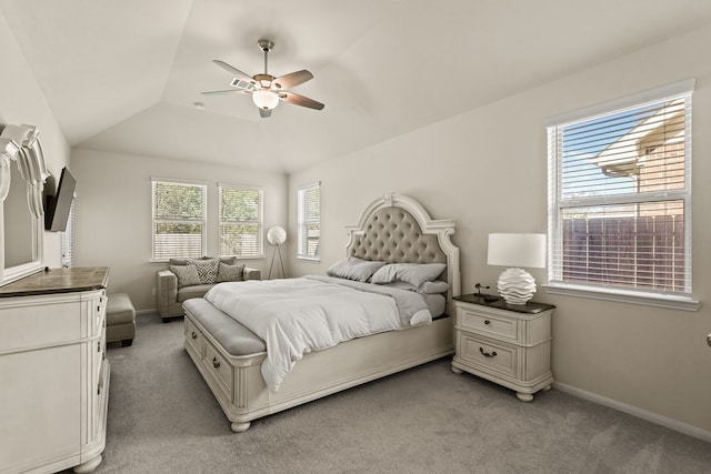 carpeted bedroom with ceiling fan and lofted ceiling