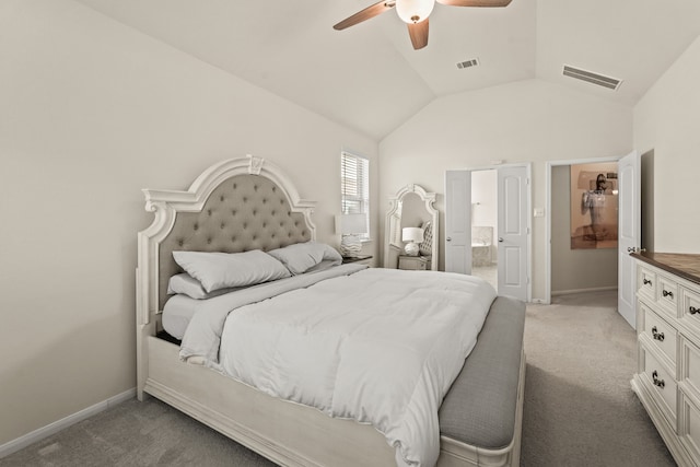 bedroom featuring light carpet, connected bathroom, vaulted ceiling, and ceiling fan