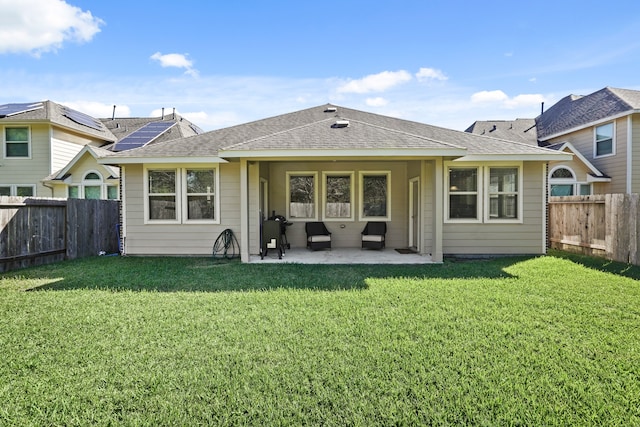 back of property featuring a patio and a lawn