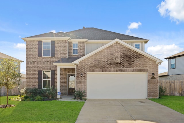 view of front of property featuring a garage and a front lawn