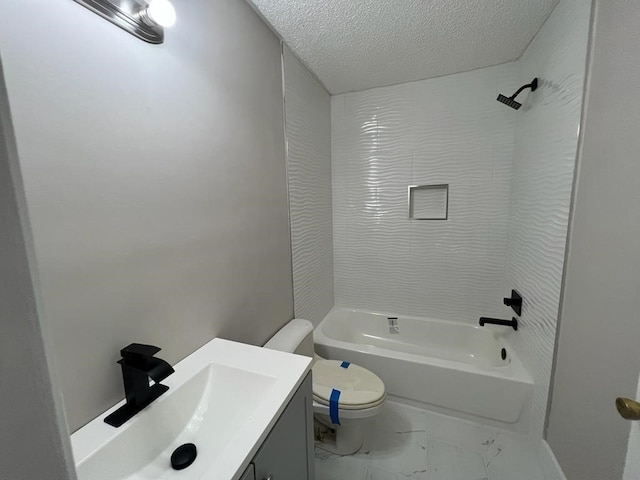 full bathroom featuring vanity, toilet, a textured ceiling, and tiled shower / bath