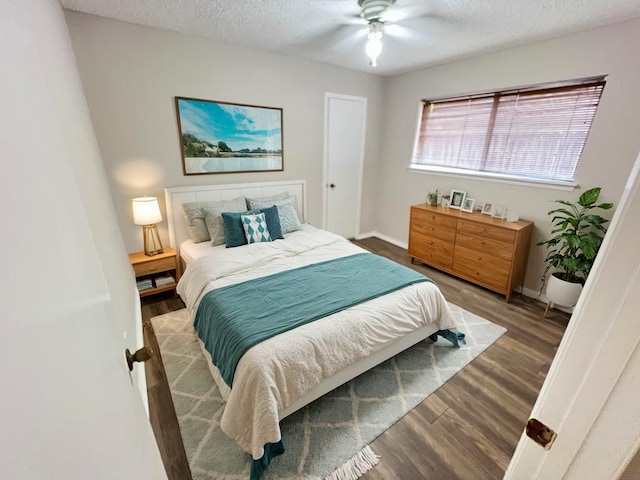 bedroom featuring ceiling fan, a textured ceiling, and hardwood / wood-style flooring