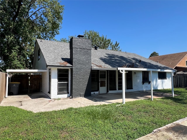 rear view of property with a lawn and a patio area