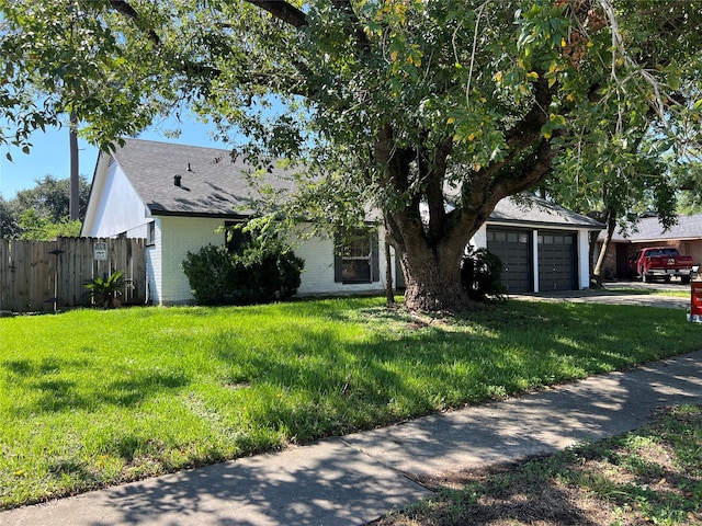 ranch-style home with a front yard and a garage