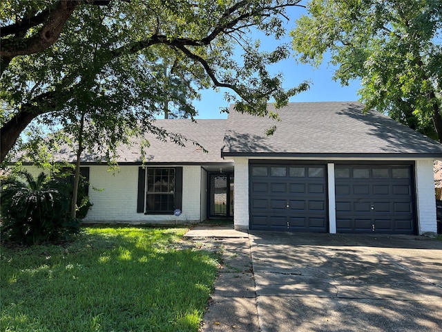 ranch-style house with a garage and a front lawn