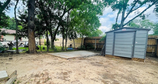 view of yard with a patio area and a storage unit