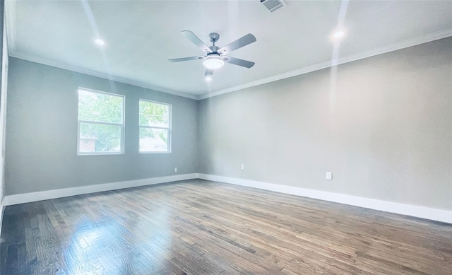 empty room with wood-type flooring, ceiling fan, and crown molding